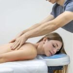 A therapist treats a woman's back, highlighting the choice between targeted rehabilitation physiotherapy and relaxing muscle massage therapy.